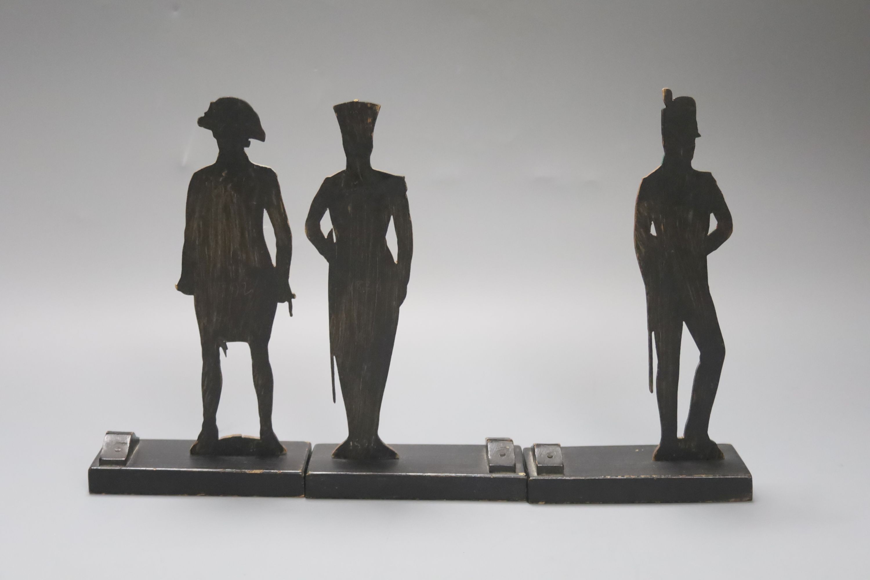 Three painted wood ‘foot officer’ menu holders 19cm